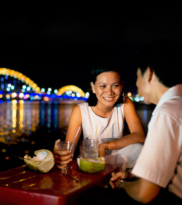 Couple have their drinks looking at the illuminated Dragon Bridge - Philips