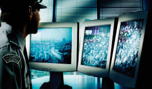 Policeman is watching the security cameras 