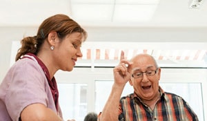 Nurse and patient in an elderly care home which supports natural biorhythms with Philips lighting