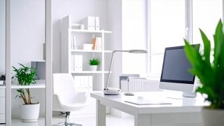 A man working at home at a cluttered desk